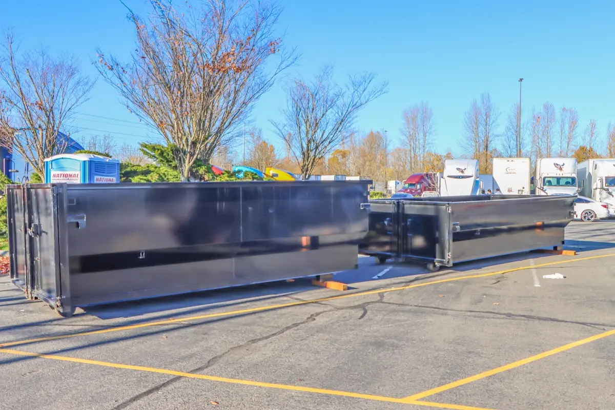 Professional dumpster rental service with roll-off container on residential driveway in Lauderdale Lakes